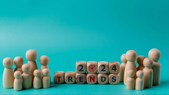 Wooden figures of people and wooden cubes with the text “2024 Trends”.