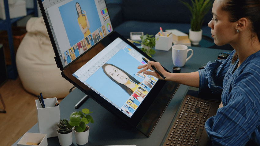 A person using a computer screen to create content, such as editing an image.