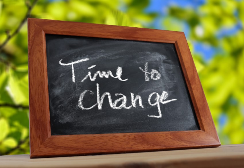 Small chalkboard in a natural setting with text Time to Change