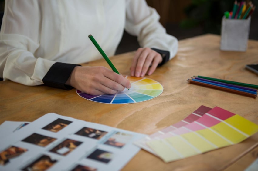 A person using a color wheel to select a color for branding purposes.