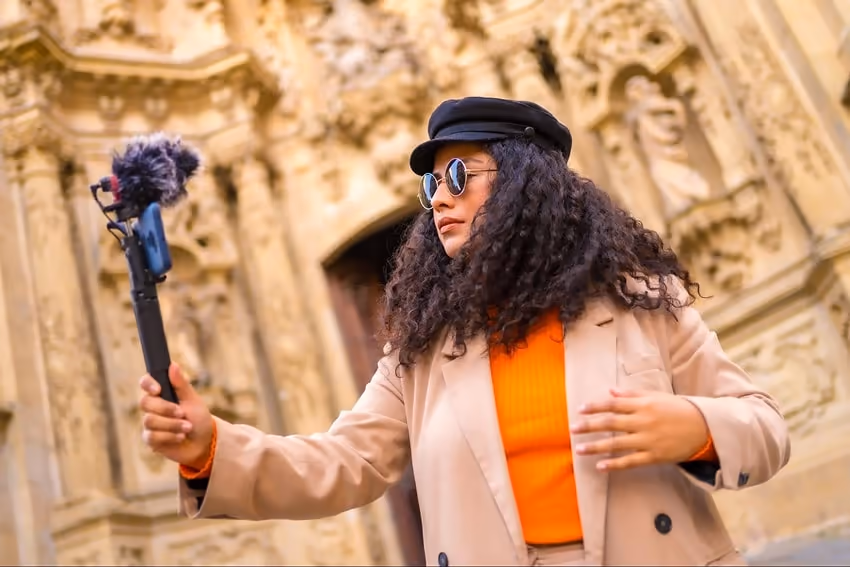 Woman holding a phone and creating content Woman holding a phone and creating content