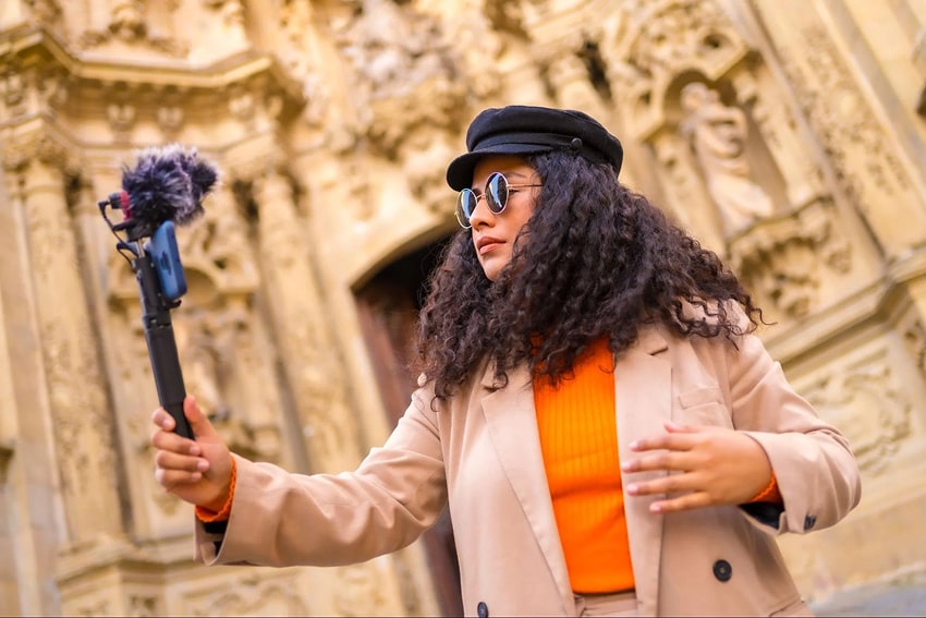 Woman holding a phone and creating content