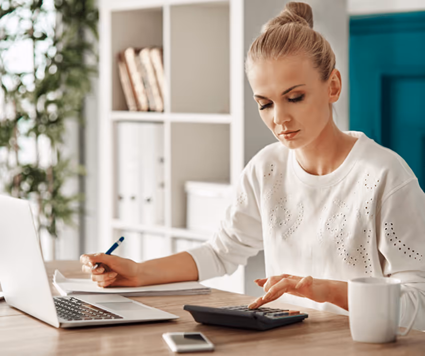 A woman calculating her budget A woman calculating her budget
