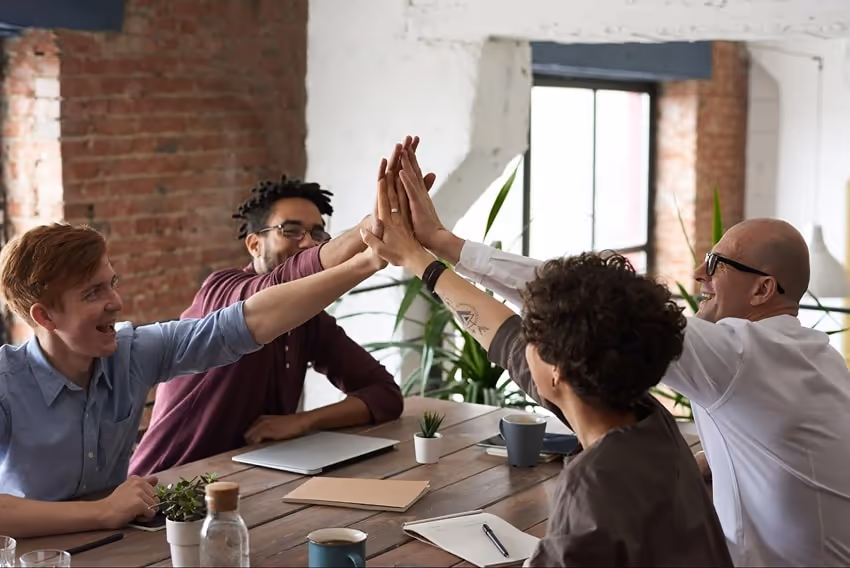 Co-workers high-fiving each other Co-workers high-fiving each other