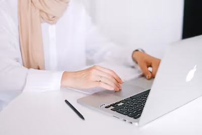 Woman typing on laptop