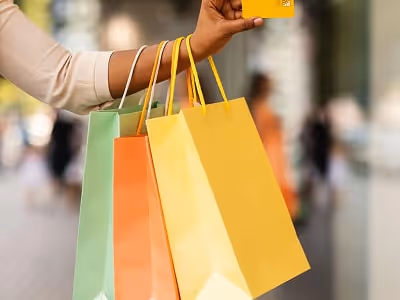 Customer holding shopping bags and a credit card Customer holding shopping bags and a credit card