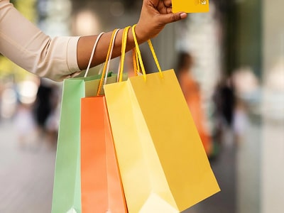 Customer holding shopping bags and a credit card