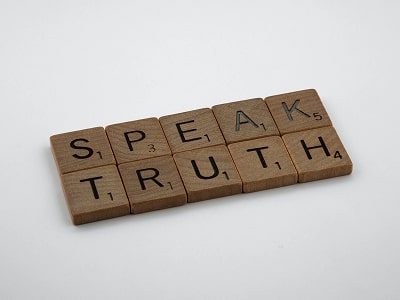 the phrase 'speak trhuth' written in wooden blocks