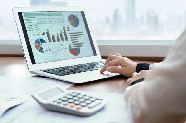 Person looking at a computer, viewing analytics.