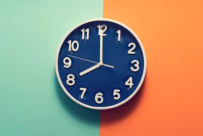 A clock in front of a green and orange background