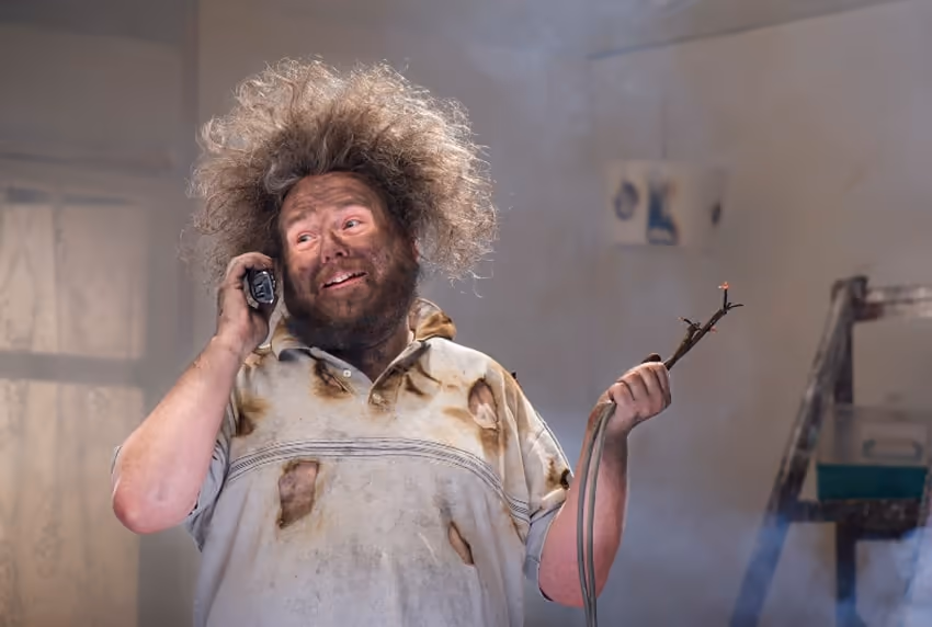 A man calling for assistance after burning something. A man calling for assistance after burning something.
