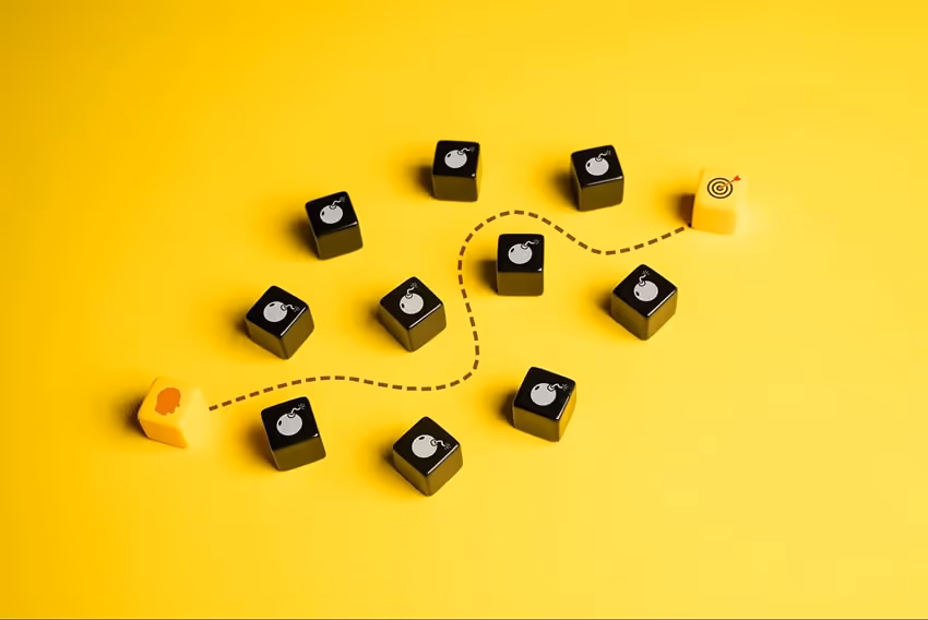 Dice with drawings of obstacles and a path drawn between them for the person to reach their target