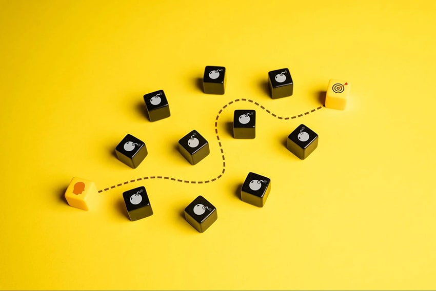 Dice with drawings of obstacles and a path drawn between them for the person to reach their target
