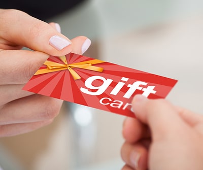 Image of someone giving a gift card to another