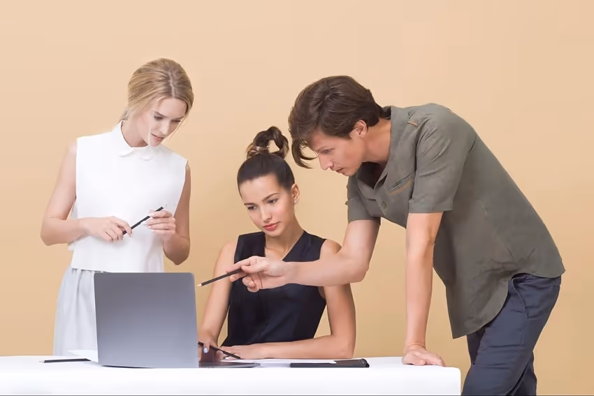 Two colleagues giving feedback to a third person Two colleagues giving feedback to a third person