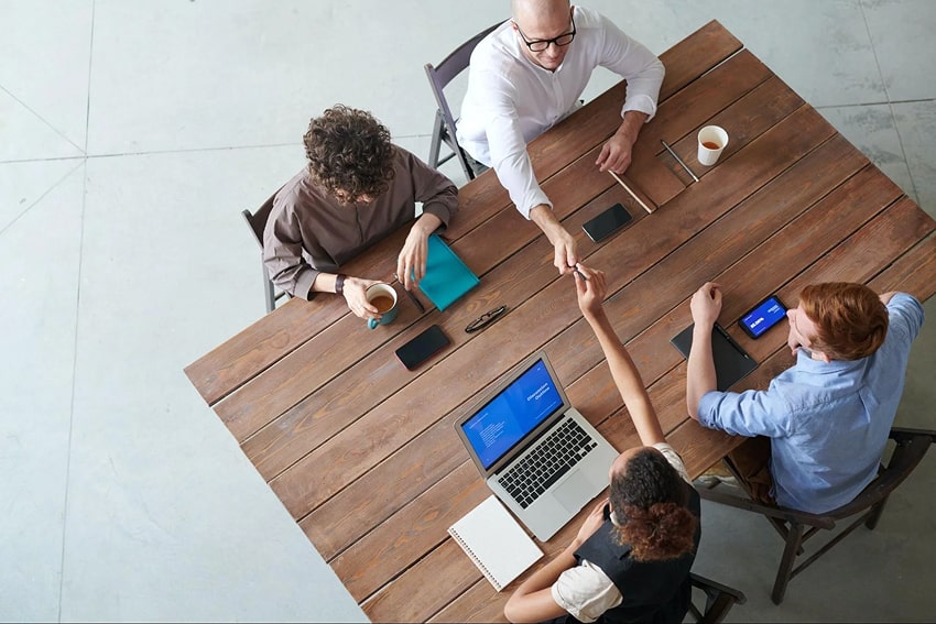 A group of people sitting at a table working together.