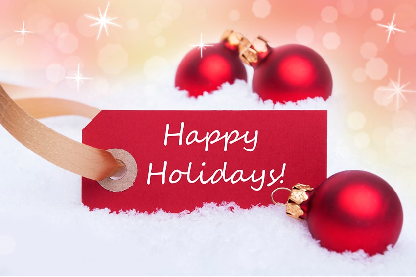 The word 'Happy Holidays' written, around Christmas decorations