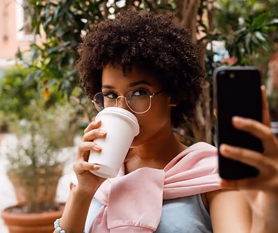 Influencer Marketing, person drinking coffee while taking a selfie