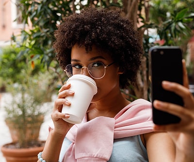 Influencer Marketing, person drinking coffee while taking a selfie