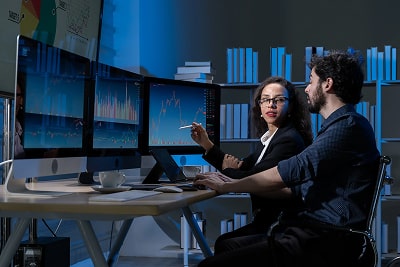 Business woman and man working on a computer