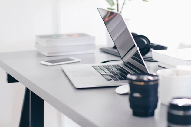 A work desk with equipment such as a laptop