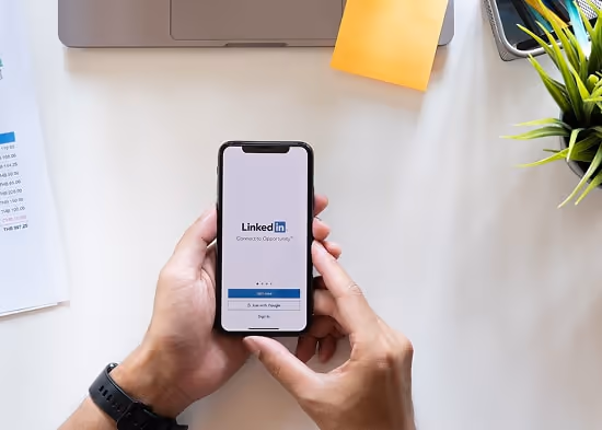 Person holding phone with LinkedIn on the screen