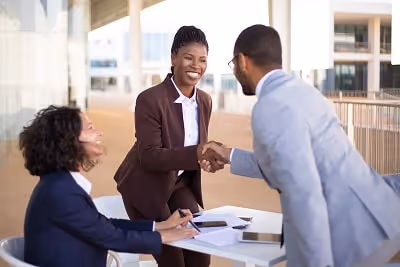 Three people making a business deal
