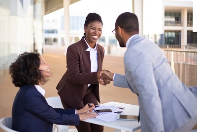 Three people making a business deal