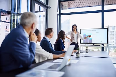 A woman holding a presentation in a business meeting