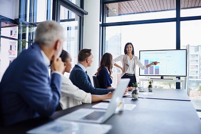 A woman holding a presentation in a business meeting