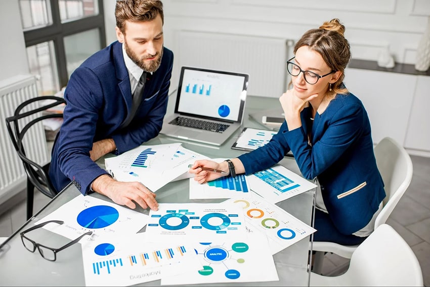 2 people analyzing data in a meeting room