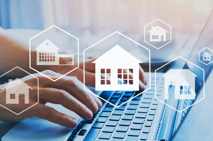 Hands on a keyboard with House icons overlaying the image