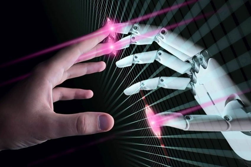 Two hands - a human one and a robotics one.