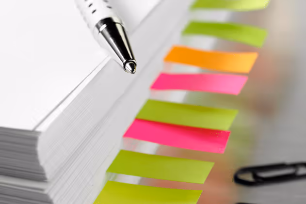 Photo of a stack of papers organized with colored sticky notes Photo of a stack of papers organized with colored sticky notes
