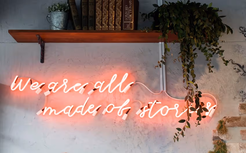 Neon sign that reads 'we are all made of stories'