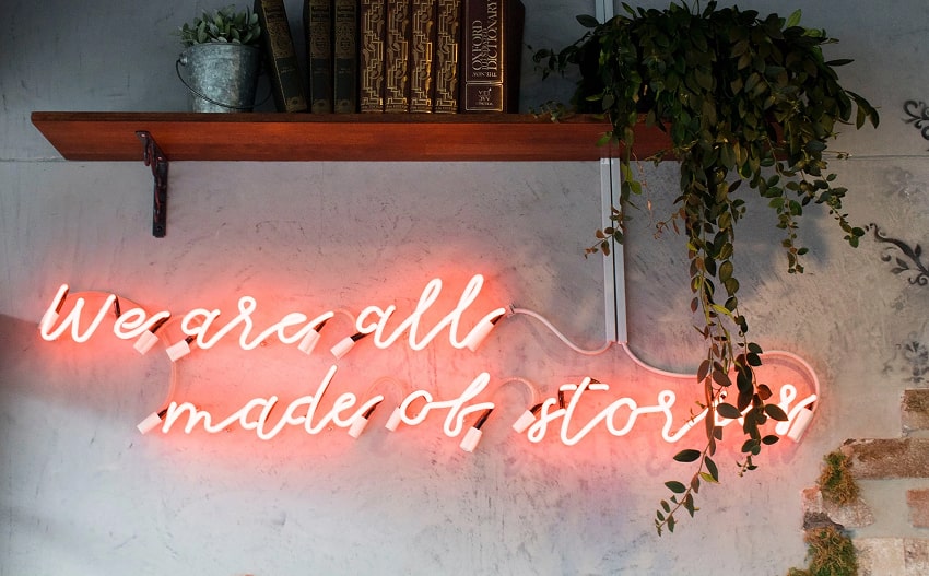 Neon sign that reads 'we are all made of stories'