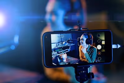 Woman recording a video with her phone Woman recording a video with her phone