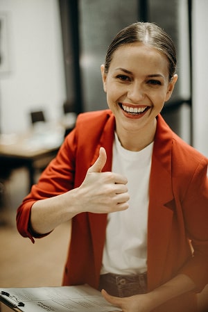 A woman holding her thumb up.