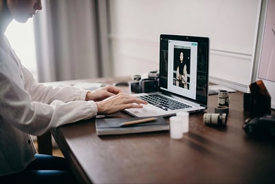 A woman working on her laptop.