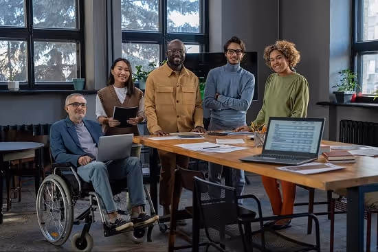 A diverse group of people in a meeting room A diverse group of people in a meeting room