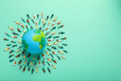 Planet earth in a green background, with several people around it.