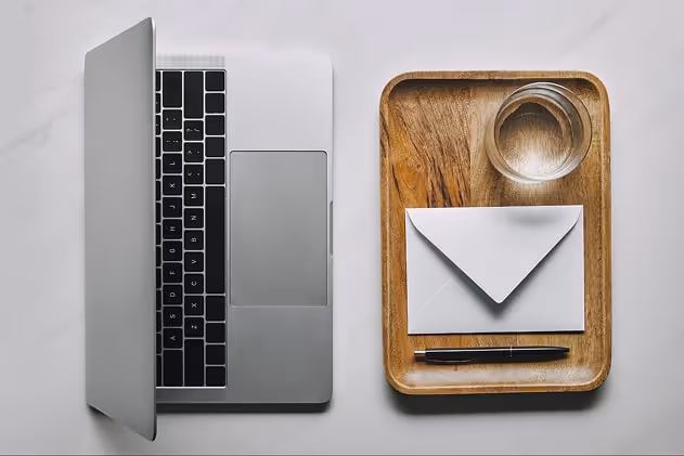 Laptop and a letter on a table Laptop and a letter on a table