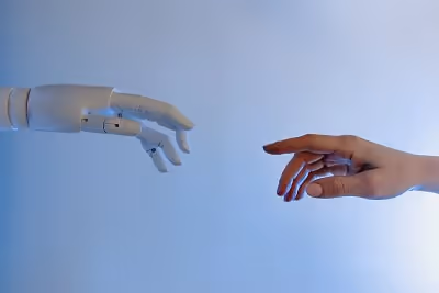 Robot and human hands touching