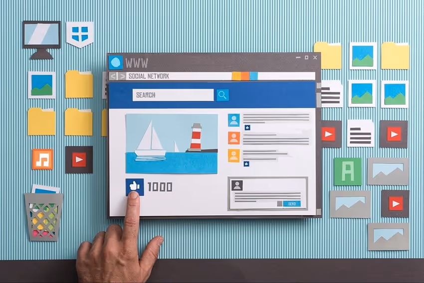 A computer workspace with icons made out of paper, social media page open and person liking a pictur A computer workspace with icons made out of paper, social media page open and person liking a pictur